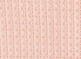 Beautiful lace cotton fabric in peach color. Layout for design. Abstract cotton texture background. The color of the year is peach fuzz. photo