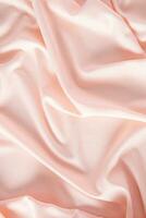 Soft pleats of peach colored satin textiles. Luxury abstract textile background design. Vertical view. Color of the Year 2024 peachy fuzz photo