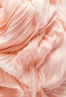 Delicate air waves of peach-colored silk fabric. Lay for design. Background image for holiday decor. Color of the Year 2024 Peach Fuzz. Vertical view photo