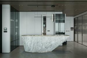 There is a white marble kitchen counter and an LED light hanging over there in the open area. photo