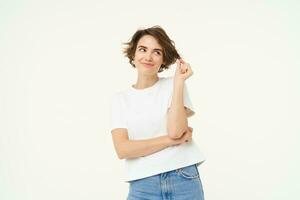 Portrait of carefree woman laughing, posing with confidence, looking self-assured and smiling, standing over white background photo