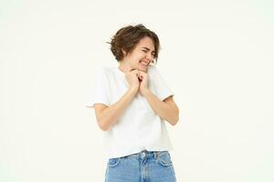 Image of woman with scared face, looks frightened, worried, trembling from fear, isolated against white background photo