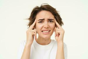 Image of woman in panic thinking, brainstorming, trying hard to remember something, standing over white background photo