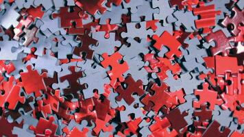 Background of Colored Puzzle Pieces that Slowly Rotating Counterclockwise Top View. Texture of Incomplete Red and Grey Jigsaw Puzzle Left Rotation video