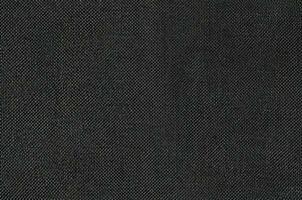 Black grey fabric texture for background and design art work with seamless pattern of natural textile. photo