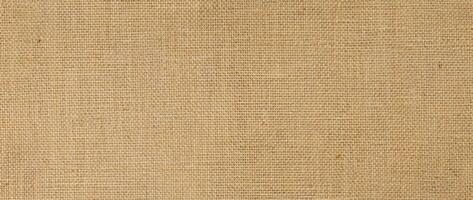 Hessian sackcloth burlap woven texture background, cotton woven fabric background with flecks of varying colors of beige and brown. with copy space. office desk concept. photo