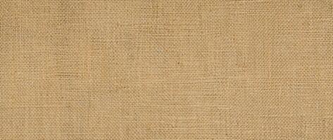 Hessian sackcloth burlap woven texture background ,cotton woven fabric background with flecks of varying colors of beige and brown. with copy space. office desk concept. photo