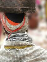 Detail, large necklaces and earrings of a Bonda tribal woman, photo