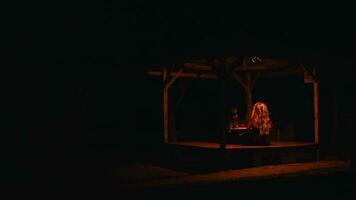 Asian people are performing rituals with a shaman in an eerie hut with red light video