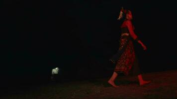 a dancer runs across an empty field crying and sad with a red glow video