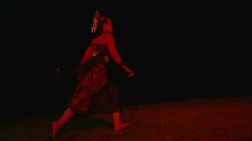 a dancer runs across an empty field crying and sad with a red glow video