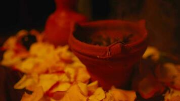 a jug and roses strewn on the table during a scary ritual video