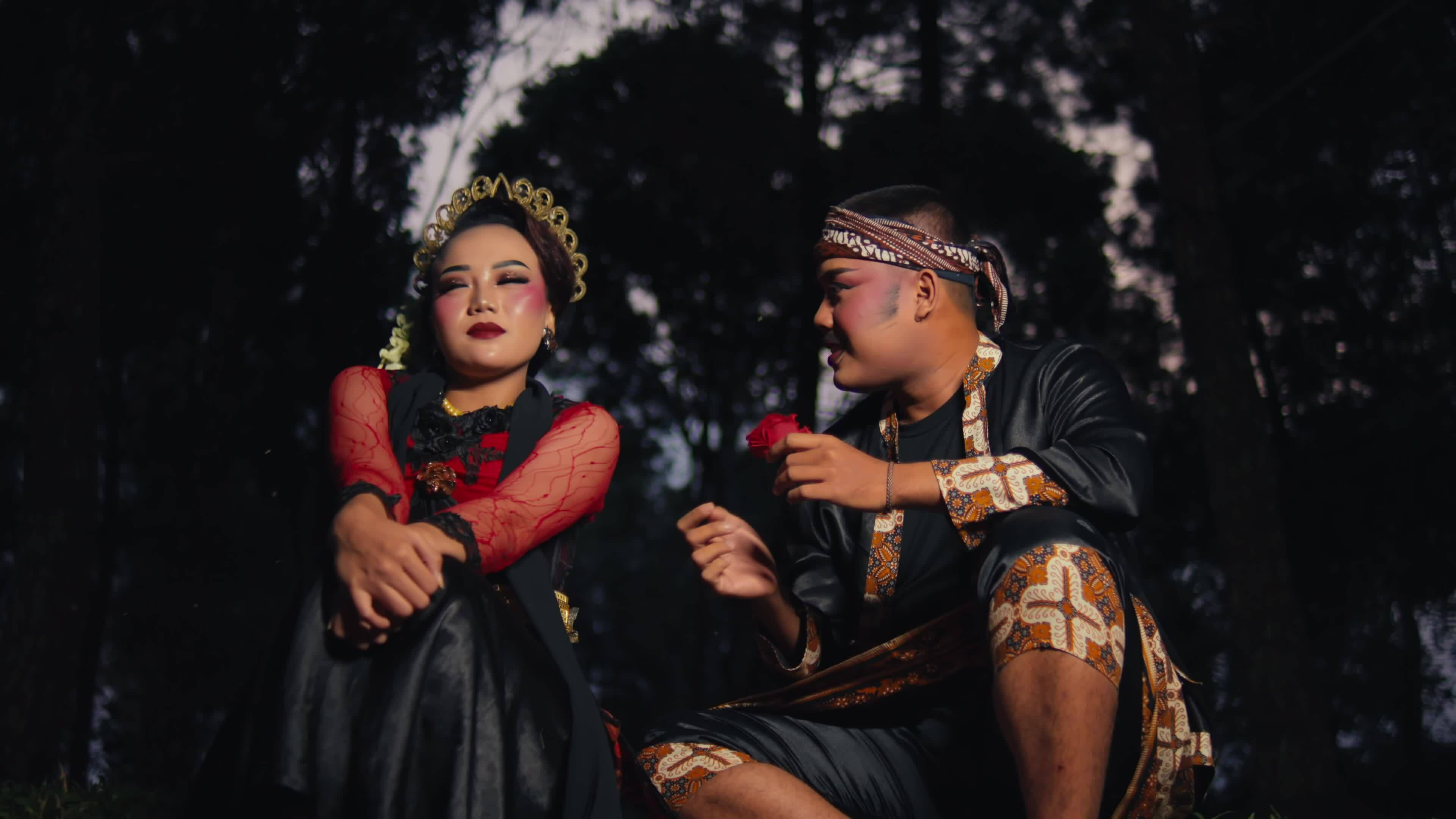 an Asian man is courting a woman very passionately using flowers an Asian man is courting a woman very passionately using flowers