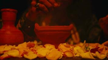 a shaman is performing a ritual with spells and offerings on a table video