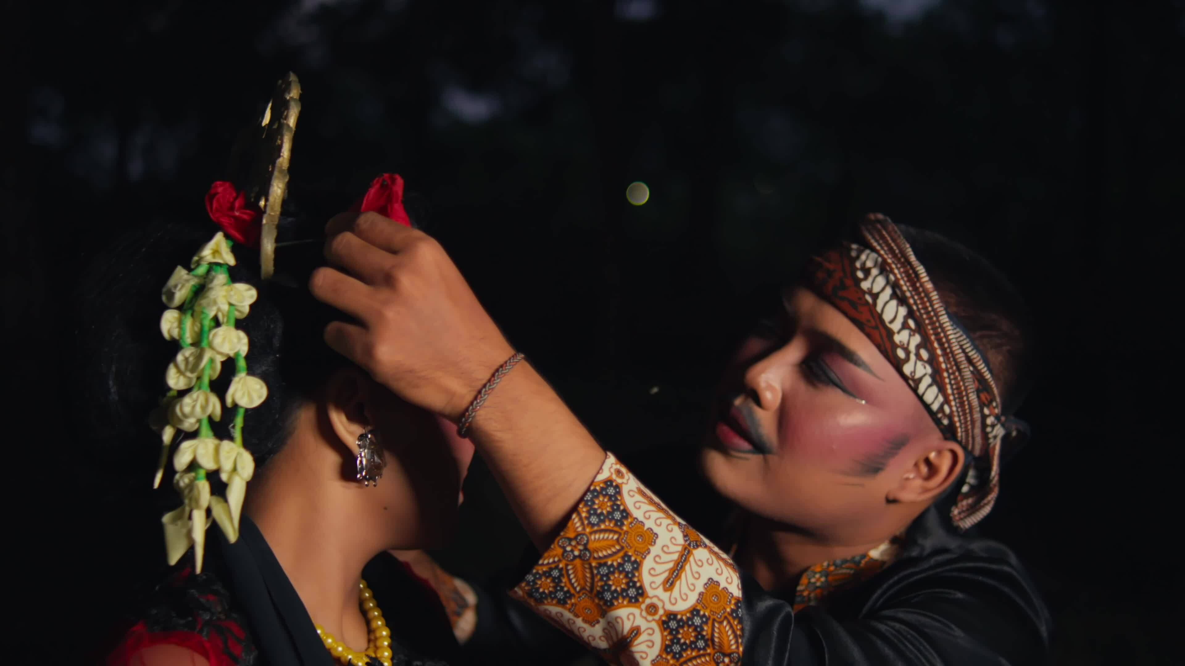an Asian man is courting a woman very passionately using flowers an Asian man is courting a woman very passionately using flowers