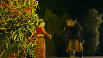 a couple dancing together on a very lively and romantic stage full of trees and warm lights video