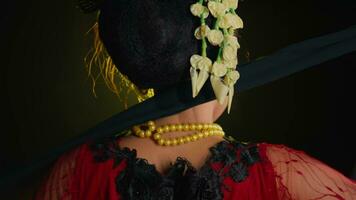 a dancer pulls a black shawl from her neck while dancing on stage video