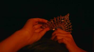 an Asian woman wears a gold hairpin on her head in a black bun video