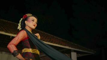 a dancer throws a black shawl at the audience while performing a dance on stage video