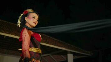 a dancer throws a black shawl at the audience while performing a dance on stage video