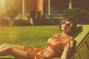 AI generated This vintage-style photo features a beautiful, well-dressed woman sitting on a lawn chair, basking in the sunshine. The image exudes a classic, timeless allure as the woman in the center of the scene captures the viewer's attention.