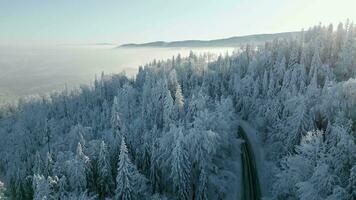 Scenic road in snowy winter mountains. Aerial video