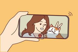 Woman with cat in phone screen during video call, for concept internet communications. Video call to friend or sister with funny kitten via smartphone to discuss news or arrange weekend meeting vector