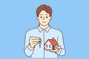 Man real estate broker holds keys and model house offering to take out mortgage on favorable terms. Real estate agent guy looks at screen and smiles, recommending to provide consultation services vector