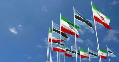 Botswana and Iran Flags Waving Together in the Sky, Seamless Loop in Wind, Space on Left Side for Design or Information, 3D Rendering video