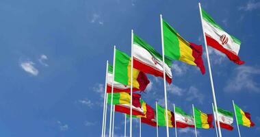 Mali and Iran Flags Waving Together in the Sky, Seamless Loop in Wind, Space on Left Side for Design or Information, 3D Rendering video