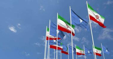 Somalia and Iran Flags Waving Together in the Sky, Seamless Loop in Wind, Space on Left Side for Design or Information, 3D Rendering video