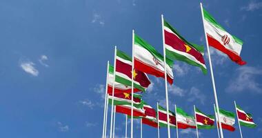 Suriname and Iran Flags Waving Together in the Sky, Seamless Loop in Wind, Space on Left Side for Design or Information, 3D Rendering video