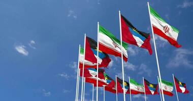 Antigua and Barbuda and Iran Flags Waving Together in the Sky, Seamless Loop in Wind, Space on Left Side for Design or Information, 3D Rendering video