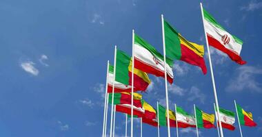 Benin and Iran Flags Waving Together in the Sky, Seamless Loop in Wind, Space on Left Side for Design or Information, 3D Rendering video