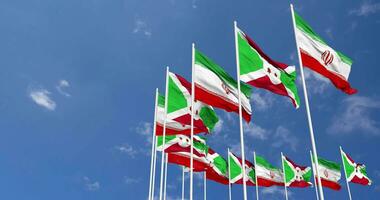 Burundi and Iran Flags Waving Together in the Sky, Seamless Loop in Wind, Space on Left Side for Design or Information, 3D Rendering video