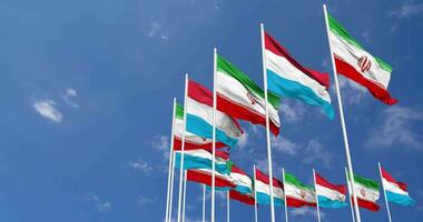 Luxembourg and Iran Flags Waving Together in the Sky, Seamless Loop in Wind, Space on Left Side for Design or Information, 3D Rendering video