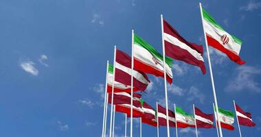 Latvia and Iran Flags Waving Together in the Sky, Seamless Loop in Wind, Space on Left Side for Design or Information, 3D Rendering video