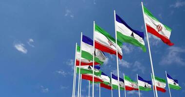 Lesotho and Iran Flags Waving Together in the Sky, Seamless Loop in Wind, Space on Left Side for Design or Information, 3D Rendering video