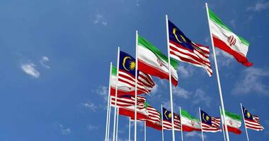 Malaysia and Iran Flags Waving Together in the Sky, Seamless Loop in Wind, Space on Left Side for Design or Information, 3D Rendering video