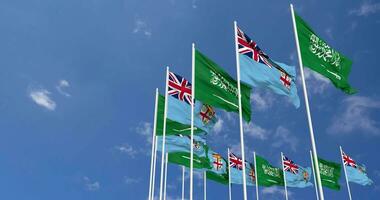 Fiji and KSA, Kingdom of Saudi Arabia Flags Waving Together in the Sky, Seamless Loop in Wind, Space on Left Side for Design or Information, 3D Rendering video