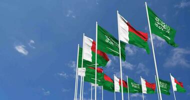 Madagascar and KSA, Kingdom of Saudi Arabia Flags Waving Together in the Sky, Seamless Loop in Wind, Space on Left Side for Design or Information, 3D Rendering video