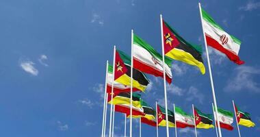 Mozambique and Iran Flags Waving Together in the Sky, Seamless Loop in Wind, Space on Left Side for Design or Information, 3D Rendering video