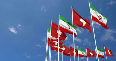 Switzerland and Iran Flags Waving Together in the Sky, Seamless Loop in Wind, Space on Left Side for Design or Information, 3D Rendering video