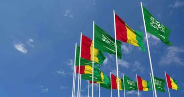 Guinea and KSA, Kingdom of Saudi Arabia Flags Waving Together in the Sky, Seamless Loop in Wind, Space on Left Side for Design or Information, 3D Rendering video