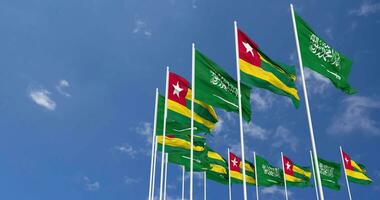 Togo and KSA, Kingdom of Saudi Arabia Flags Waving Together in the Sky, Seamless Loop in Wind, Space on Left Side for Design or Information, 3D Rendering video