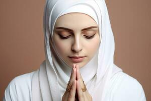 AI generated A Muslim woman in a white burka praying with her hands together photo