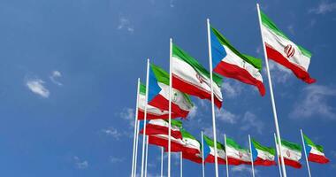 Equatorial Guinea and Iran Flags Waving Together in the Sky, Seamless Loop in Wind, Space on Left Side for Design or Information, 3D Rendering video