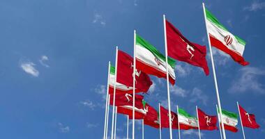 Isle of Man and Iran Flags Waving Together in the Sky, Seamless Loop in Wind, Space on Left Side for Design or Information, 3D Rendering video