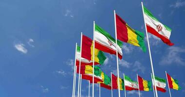 Guinea and Iran Flags Waving Together in the Sky, Seamless Loop in Wind, Space on Left Side for Design or Information, 3D Rendering video