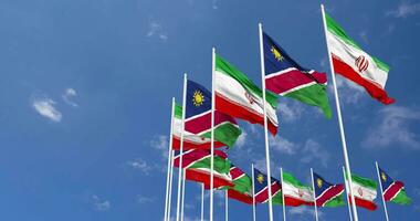 Namibia and Iran Flags Waving Together in the Sky, Seamless Loop in Wind, Space on Left Side for Design or Information, 3D Rendering video